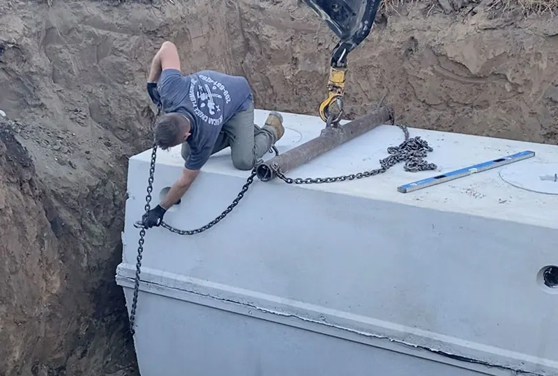 Tank Installation by Lowering Tank into Hole via Crane